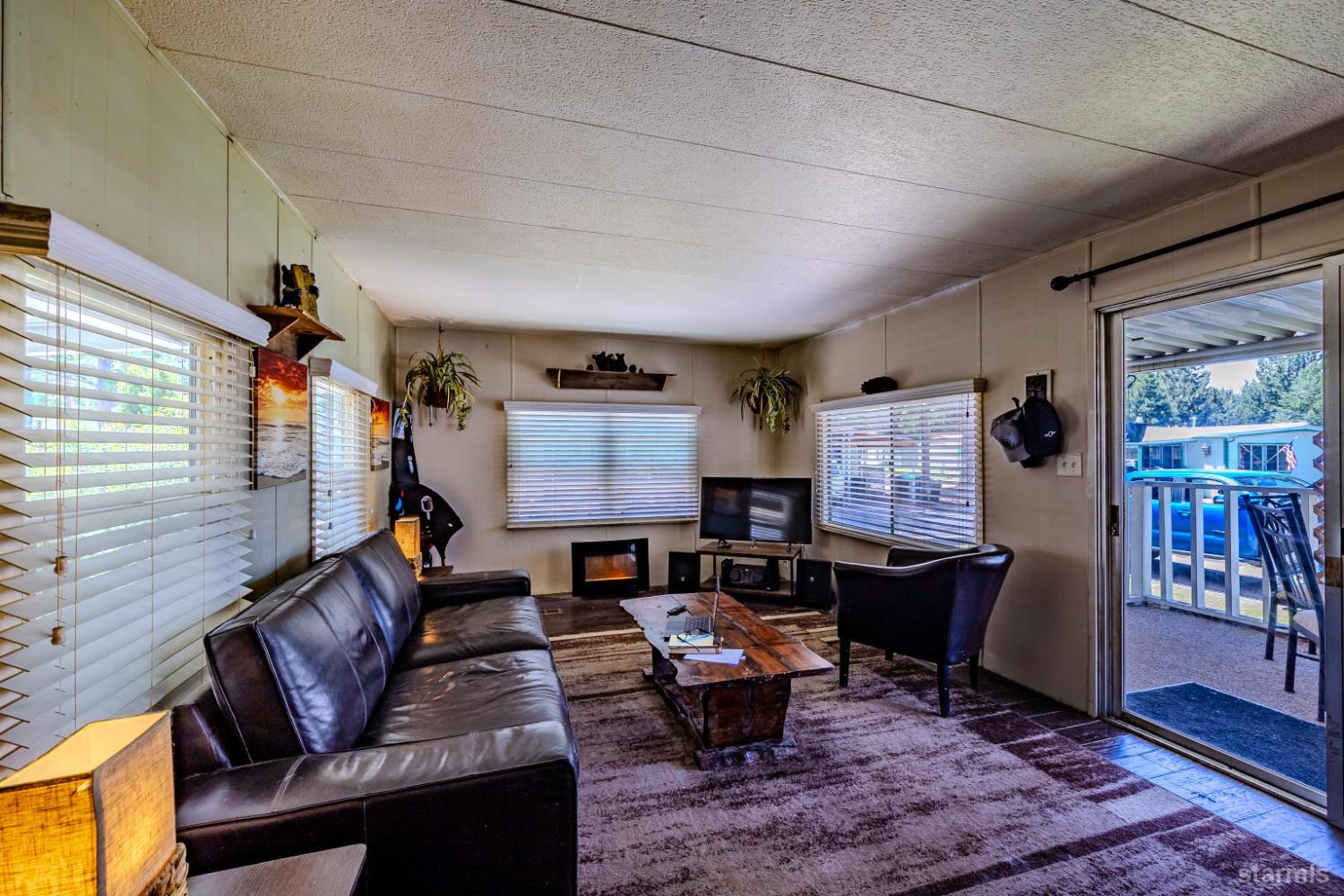 1080 Julie Lane, Unit 140 South Lake Tahoe, CA 96150 - Photo 8 of 20 a living room with furniture a rug and a window