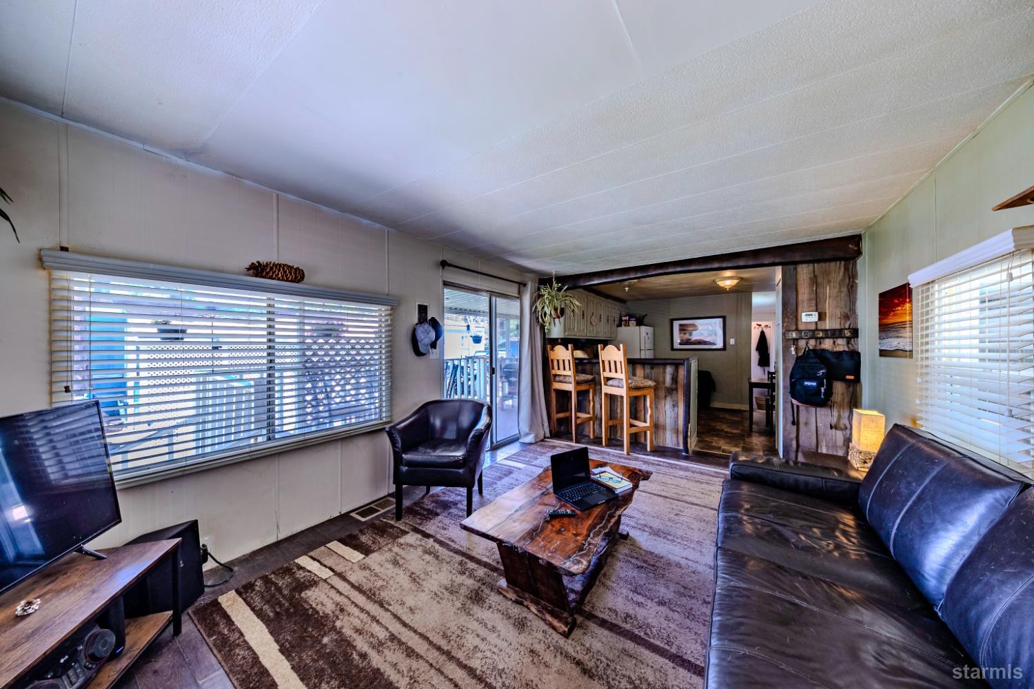 1080 Julie Lane, Unit 140 South Lake Tahoe, CA 96150 - Photo 9 of 20 a living room with furniture a rug and a large window