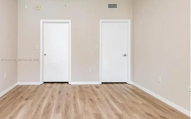 a close view of a sink and dishwasher with wooden floor