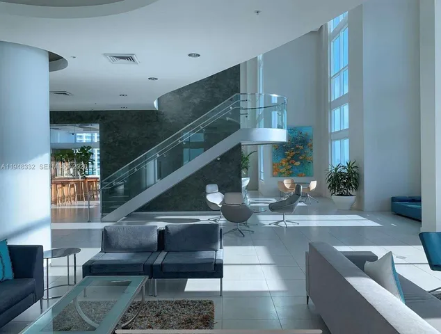 a living room with furniture and stairs