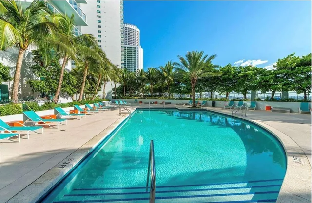 a swimming pool with some trees in the background