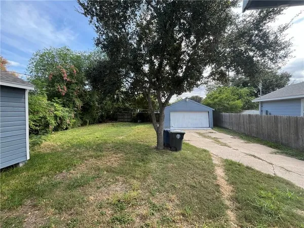 a backyard of a house with yard and trampoline
