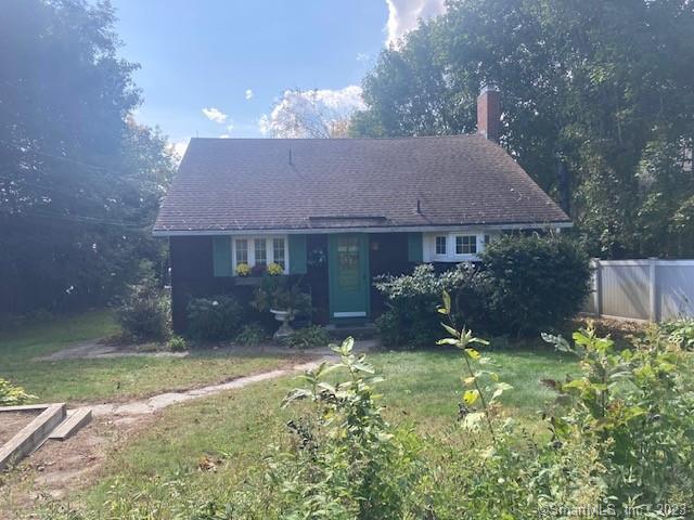 a view of a house with a yard and plants