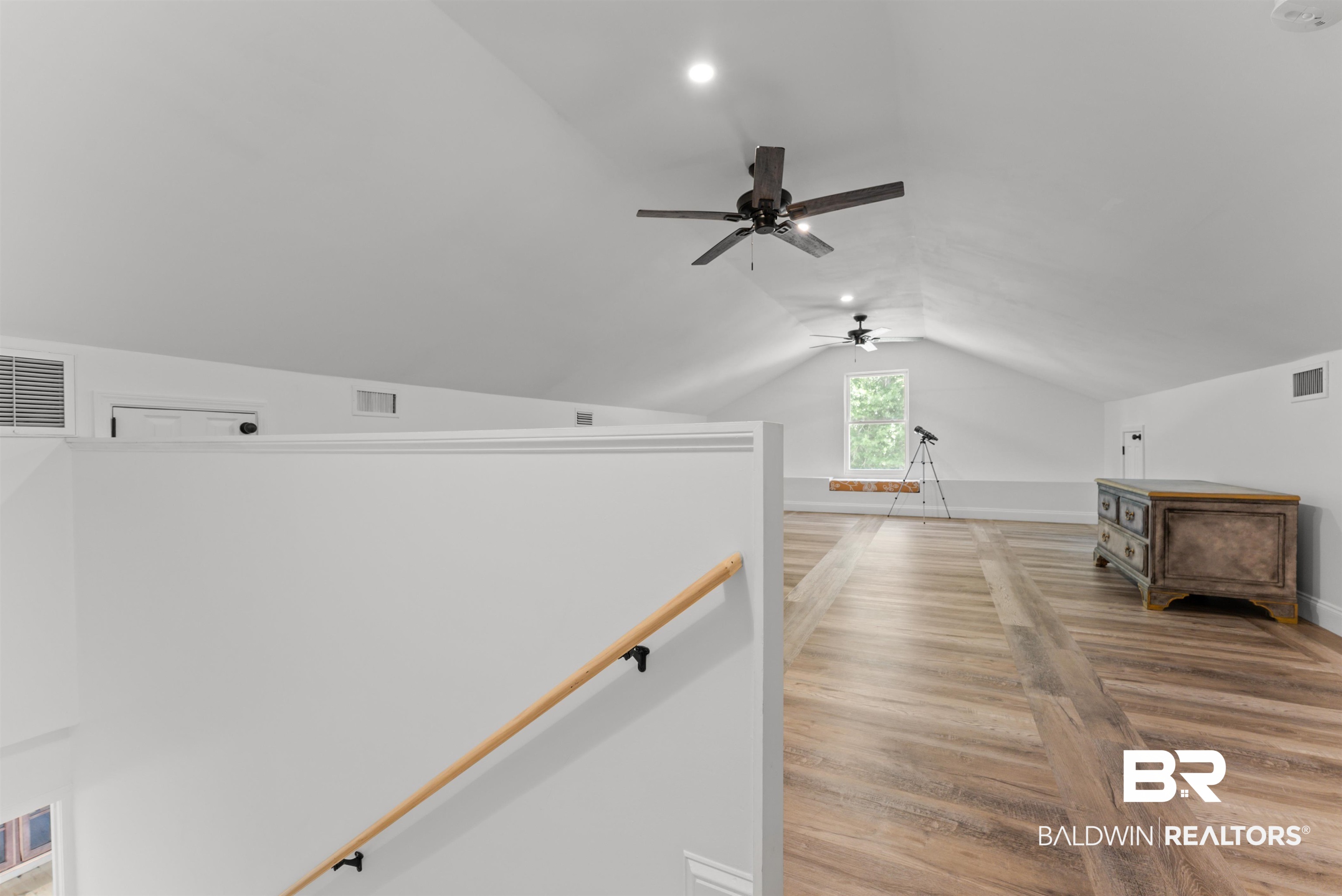 6447 Bemis Lane Bon Secour, AL 36511 - Photo 39 of 62 Expansive attic space featuring vaulted ceilings, recessed lighting, and wood-finish flooring