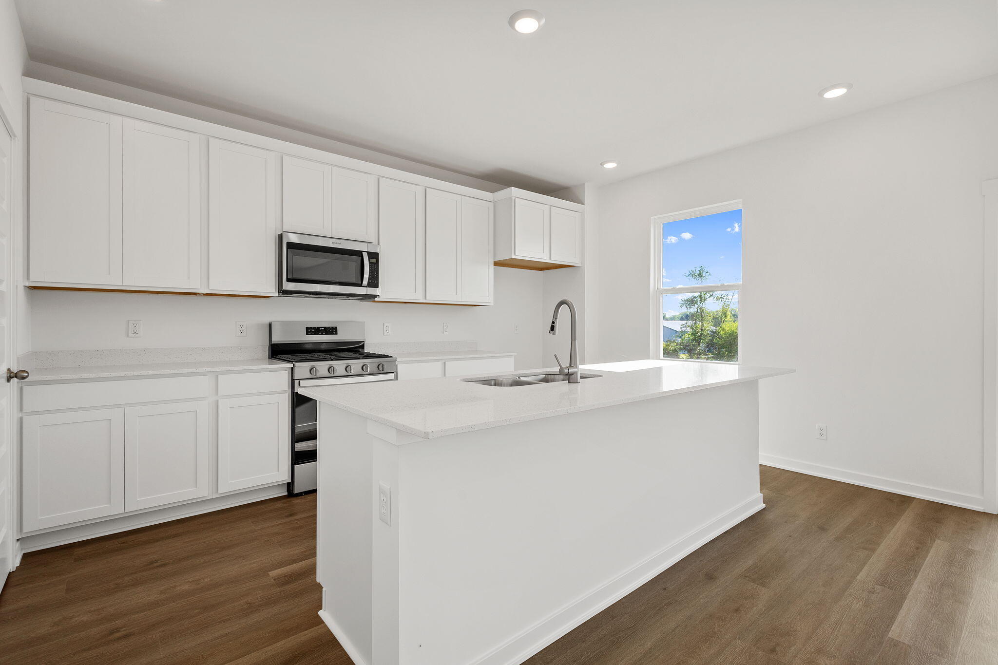 7347 West 107th Place Crown Point, IN 46307 - Photo 6 of 26 a kitchen with appliances a sink and cabinets