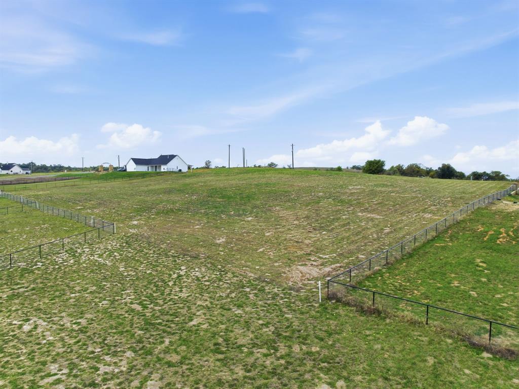 Lot 8 North Agnes Road Springtown, TX 76082 - Photo 30 of 32 a view of a green field with wooden fence