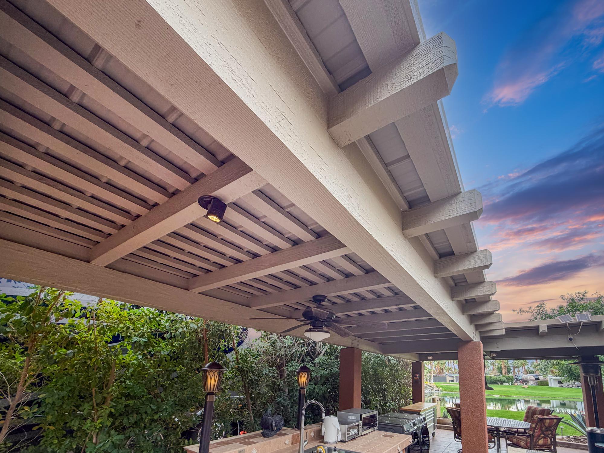 80394 Ave 48, Unit 281 Indio, CA 92201 - Photo 14 of 15 a view of a patio with table and chairs under an umbrella with a roof