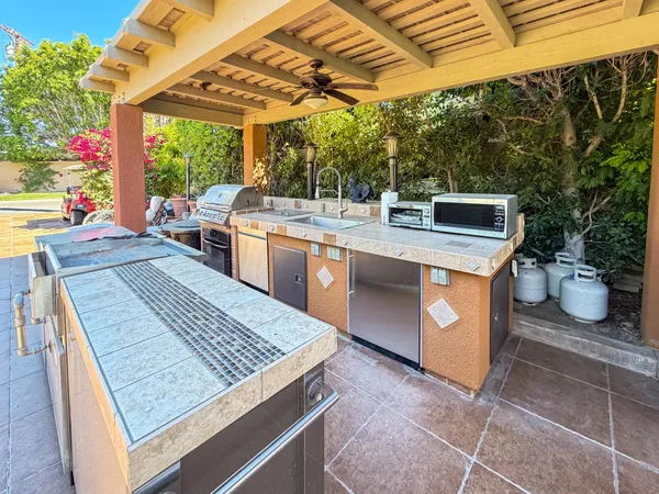 a kitchen with a stove a sink and a microwave