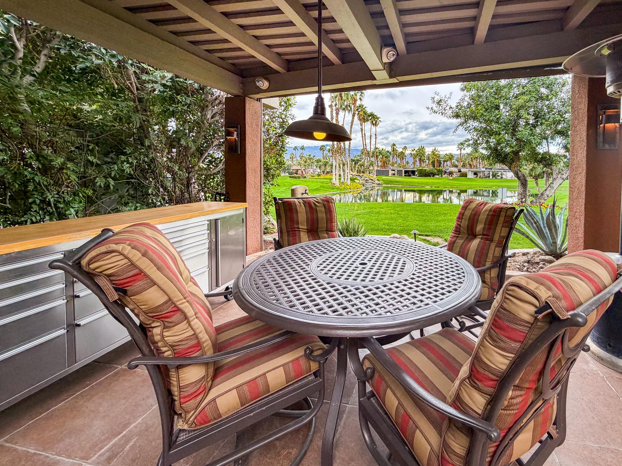 80394 Ave 48, Unit 281 Indio, CA 92201 - Photo 6 of 15 a view of a patio with a table chairs and a backyard
