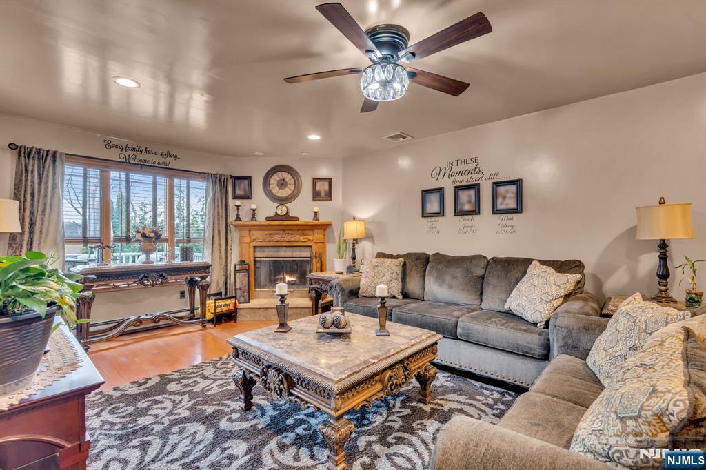 104 Prospect Street Nutley, NJ 07110 - Photo 11 of 41 a living room with furniture a large window and a chandelier