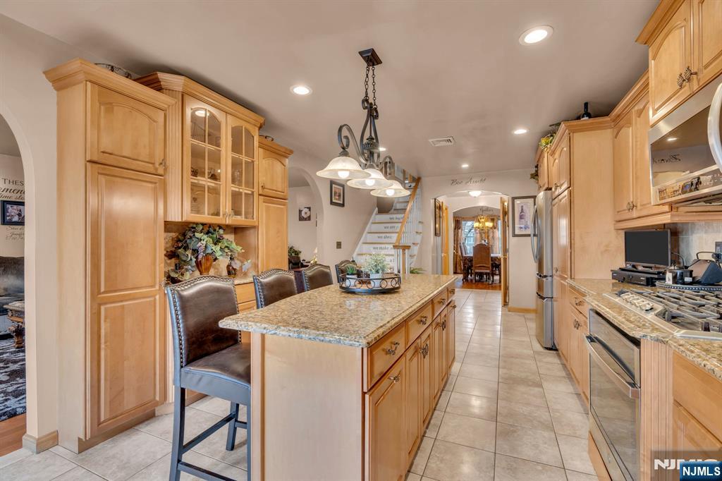 104 Prospect Street Nutley, NJ 07110 - Photo 13 of 41 a large kitchen with stainless steel appliances kitchen island granite countertop a refrigerator and a stove top oven