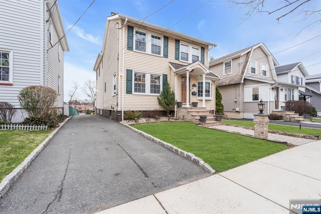 104 Prospect Street Nutley, NJ 07110 - Photo 2 of 41 a front view of a house with a garden and plants