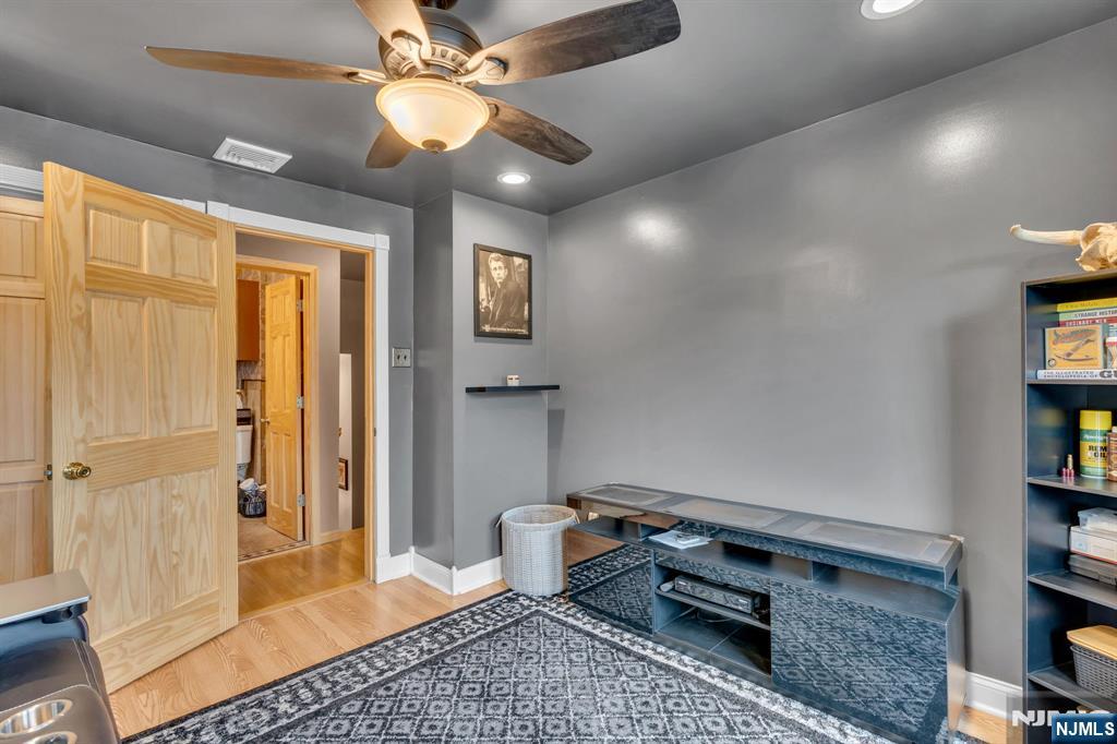 104 Prospect Street Nutley, NJ 07110 - Photo 22 of 41 a bedroom with a bed and a chandelier