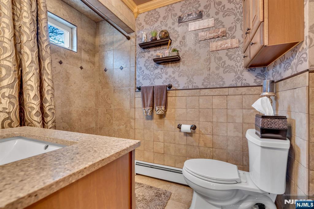 104 Prospect Street Nutley, NJ 07110 - Photo 23 of 41 a bathroom with a granite countertop toilet sink and mirror