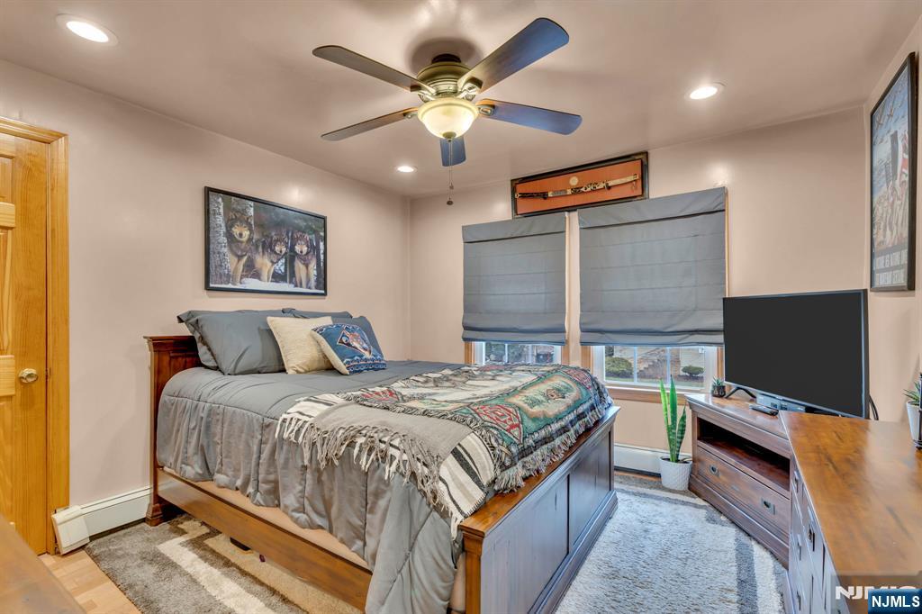 104 Prospect Street Nutley, NJ 07110 - Photo 25 of 41 a bedroom with a bed and a flat screen tv