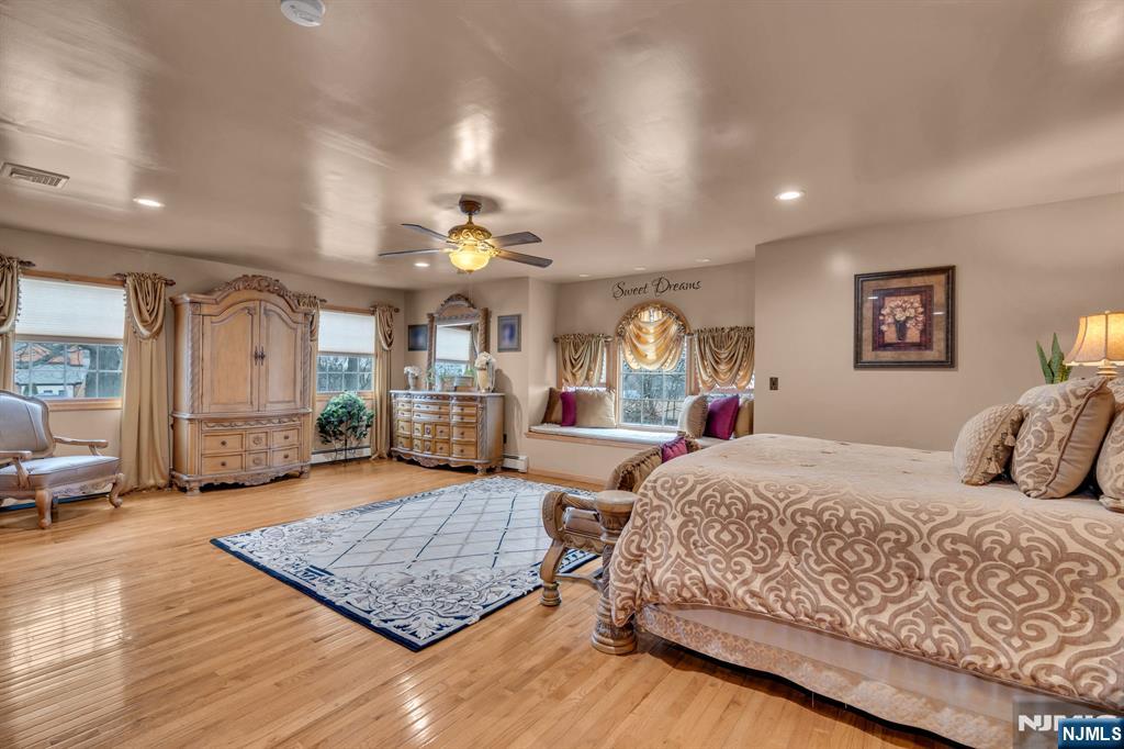 104 Prospect Street Nutley, NJ 07110 - Photo 27 of 41 a bedroom with a large bed a rug and potted plant
