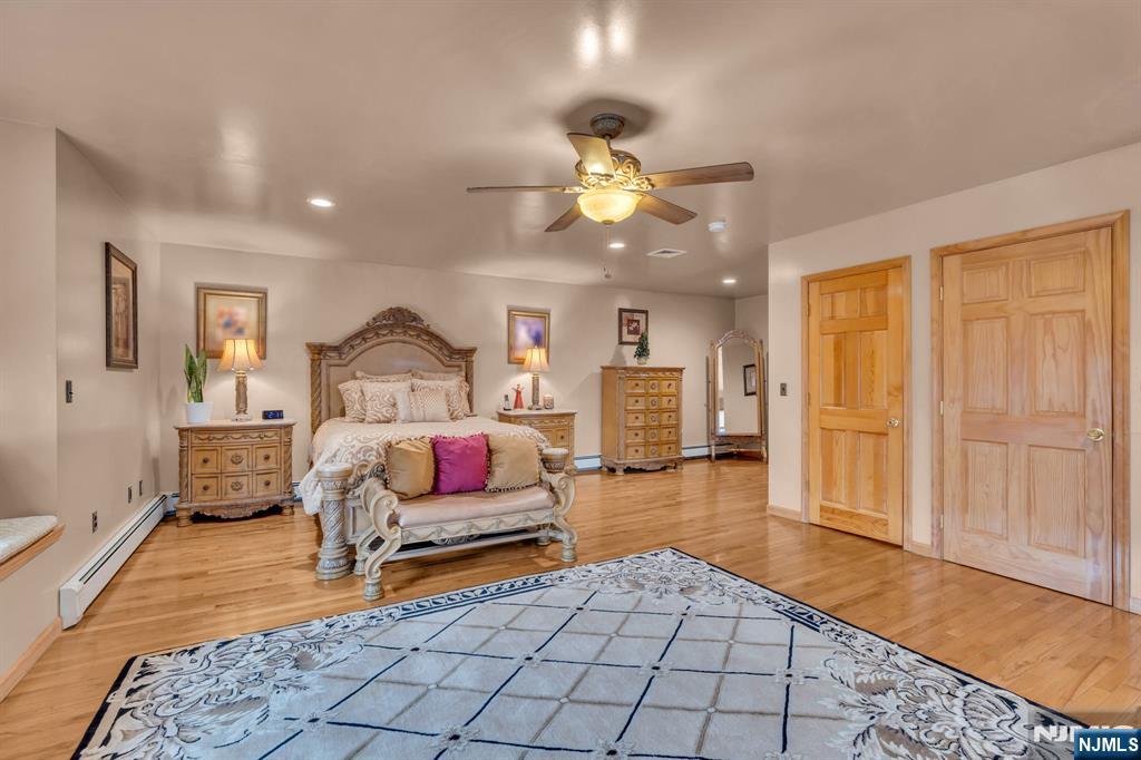 104 Prospect Street Nutley, NJ 07110 - Photo 30 of 41 a bedroom with furniture and a chandelier