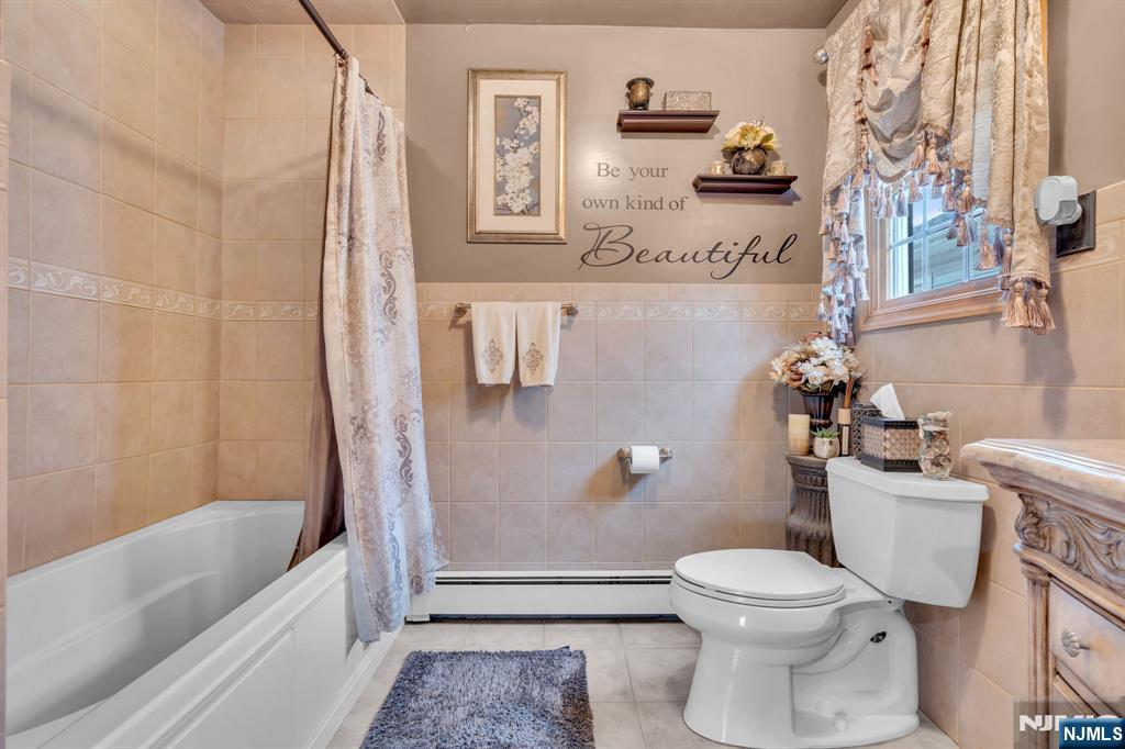 104 Prospect Street Nutley, NJ 07110 - Photo 31 of 41 a bathroom with a toilet and a bathtub