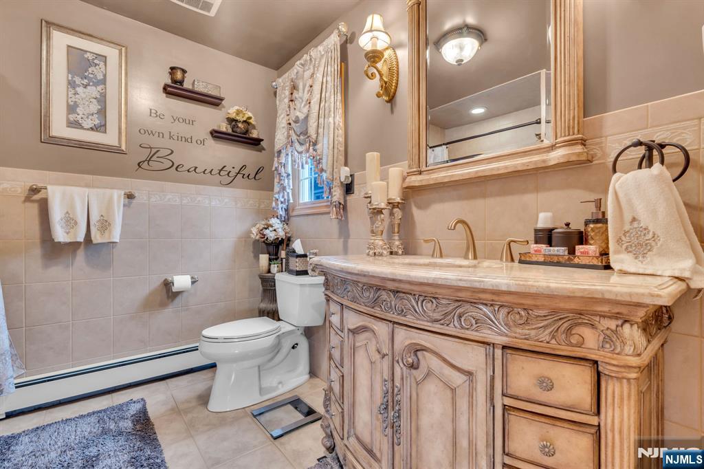 104 Prospect Street Nutley, NJ 07110 - Photo 32 of 41 a bathroom with a sink a toilet and mirror