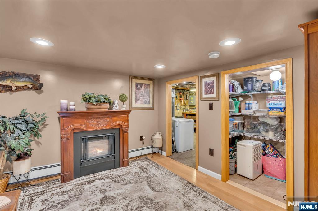104 Prospect Street Nutley, NJ 07110 - Photo 33 of 41 a living room with a fireplace cabinet and a fireplace