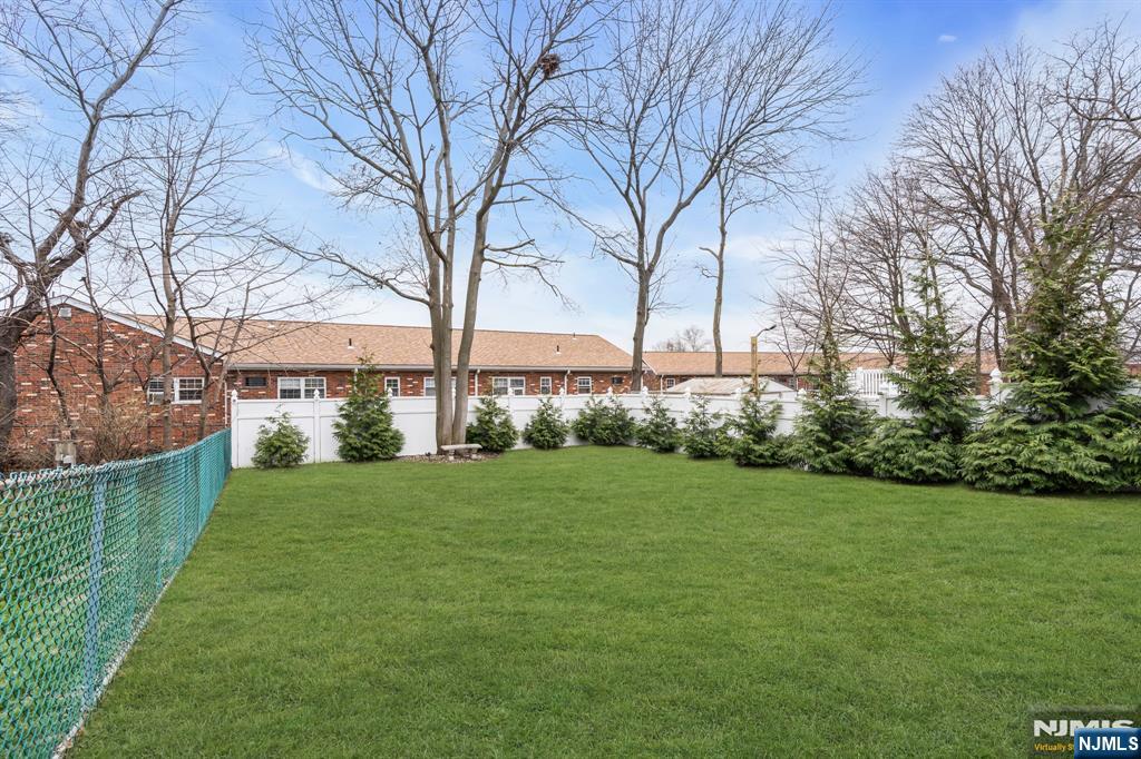 104 Prospect Street Nutley, NJ 07110 - Photo 38 of 41 a view of a big yard next to a building