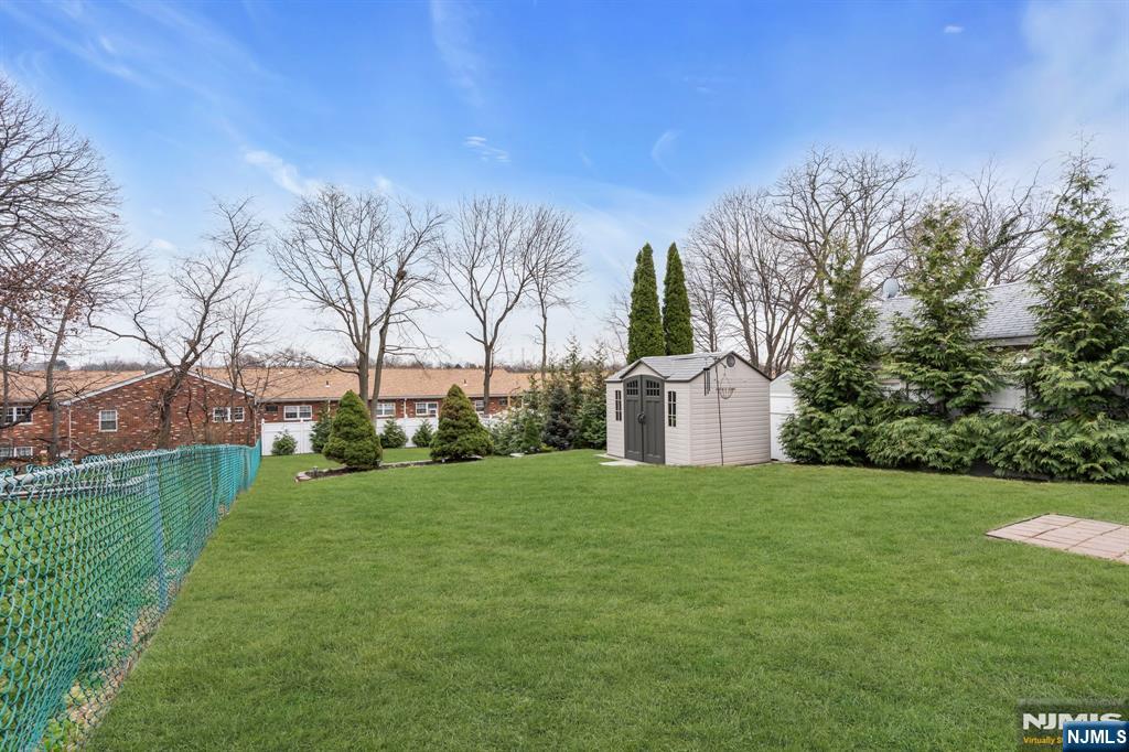 104 Prospect Street Nutley, NJ 07110 - Photo 40 of 41 a view of a big house with a big yard and large trees