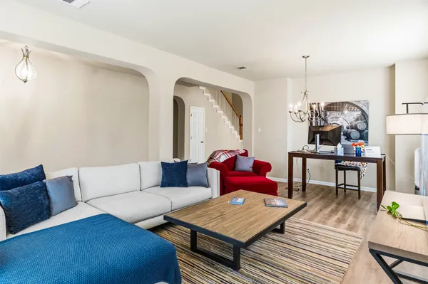 a living room with furniture a rug and a table