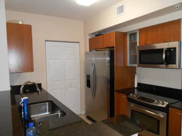 a kitchen with stainless steel appliances a refrigerator and a stove top oven