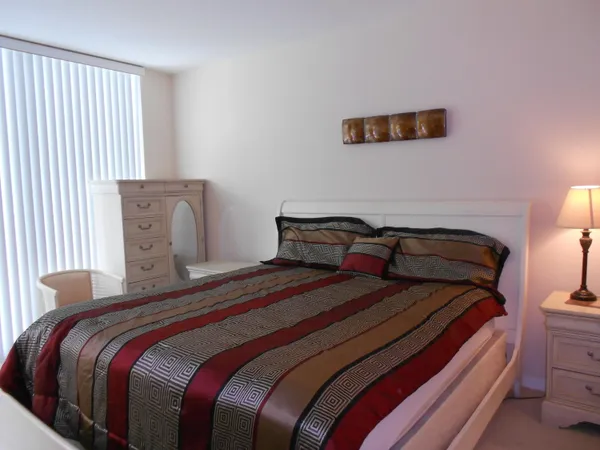 a bedroom with bed and a night stand