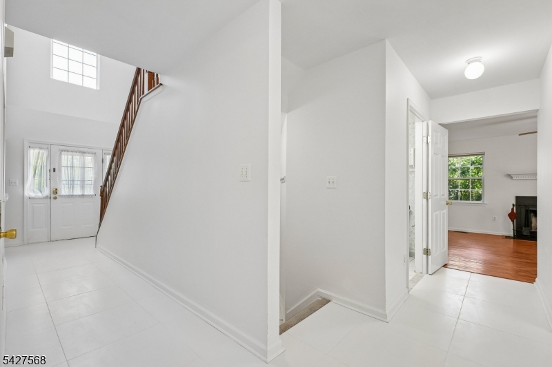 1 Leigh Road Hillsborough, NJ 08844 - Photo 11 of 35 a view of a hallway with wooden floor and a living room
