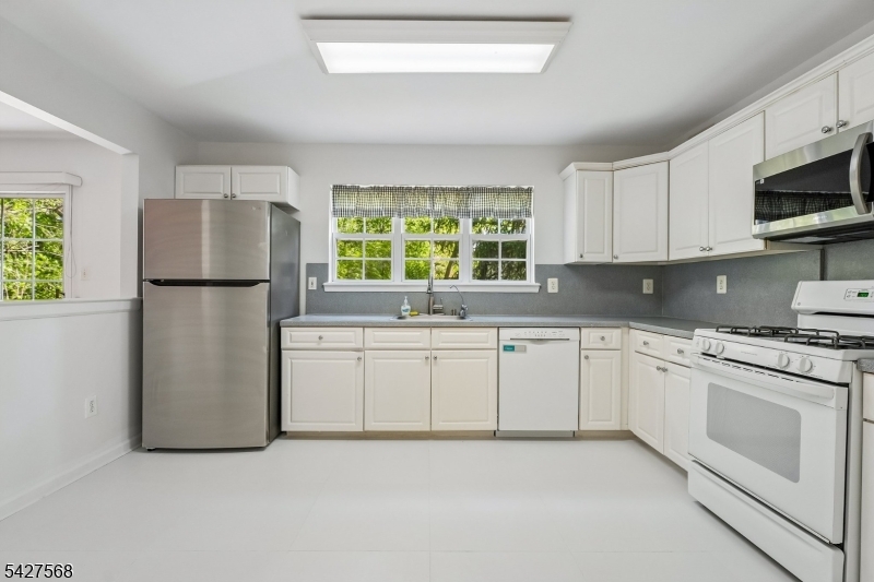 1 Leigh Road Hillsborough, NJ 08844 - Photo 12 of 35 a kitchen with a refrigerator sink and microwave