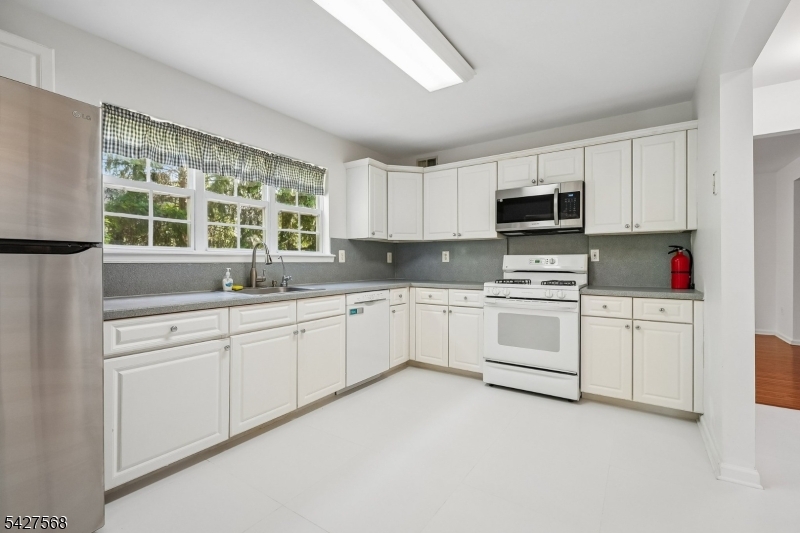 1 Leigh Road Hillsborough, NJ 08844 - Photo 13 of 35 a kitchen with cabinets appliances a sink and a window