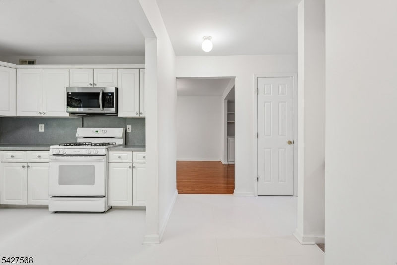 1 Leigh Road Hillsborough, NJ 08844 - Photo 14 of 35 a kitchen with granite countertop white cabinets and stainless steel appliances