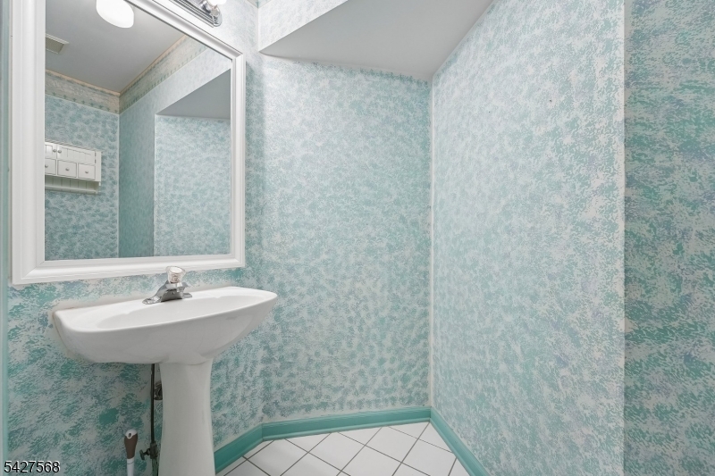 1 Leigh Road Hillsborough, NJ 08844 - Photo 18 of 35 a bathroom with a sink a mirror and shower