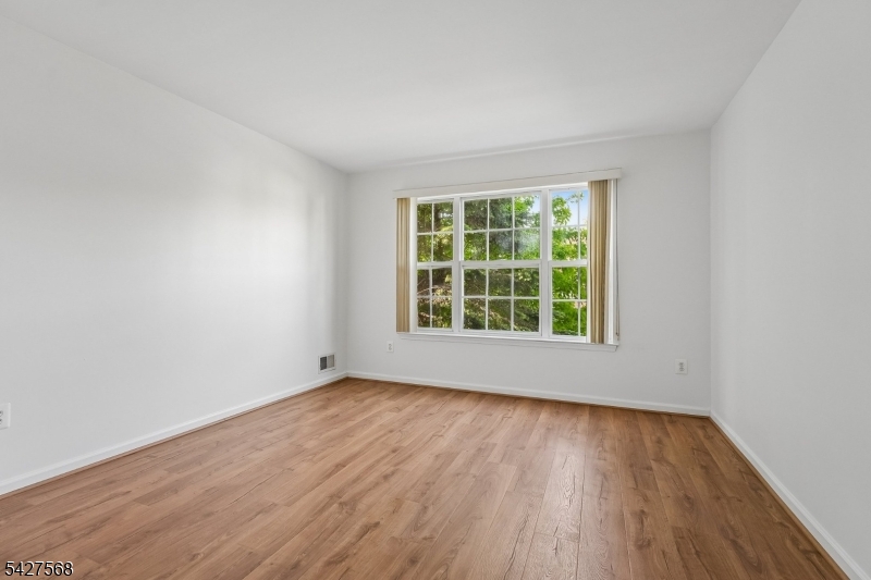 1 Leigh Road Hillsborough, NJ 08844 - Photo 30 of 35 a view of an empty room with wooden floor and a window