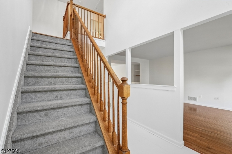 1 Leigh Road Hillsborough, NJ 08844 - Photo 4 of 35 a view of staircase with wooden floor and white walls