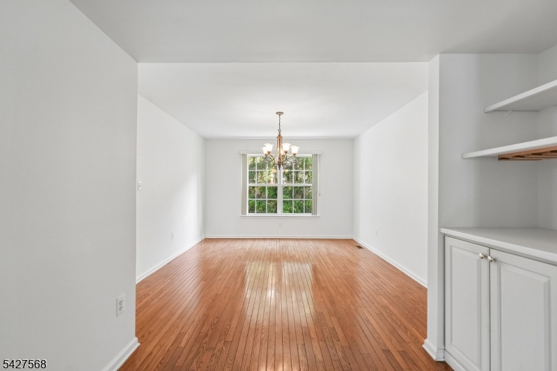 1 Leigh Road Hillsborough, NJ 08844 - Photo 8 of 35 a view of an empty room with wooden floor and a window