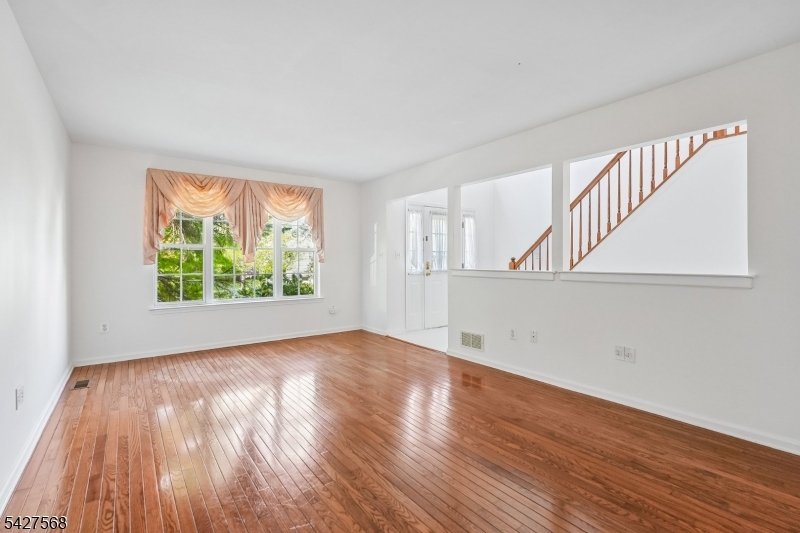 1 Leigh Road Hillsborough, NJ 08844 - Photo 9 of 35 a view of an empty room with wooden floor and a window