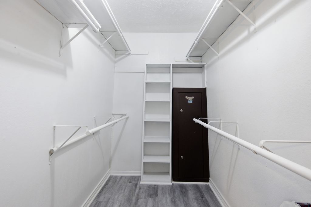 1454 Red Town Road Elgin, TX 78621 - Photo 13 of 40 A well-organized closet offers ample storage with shelving and hanging rods.