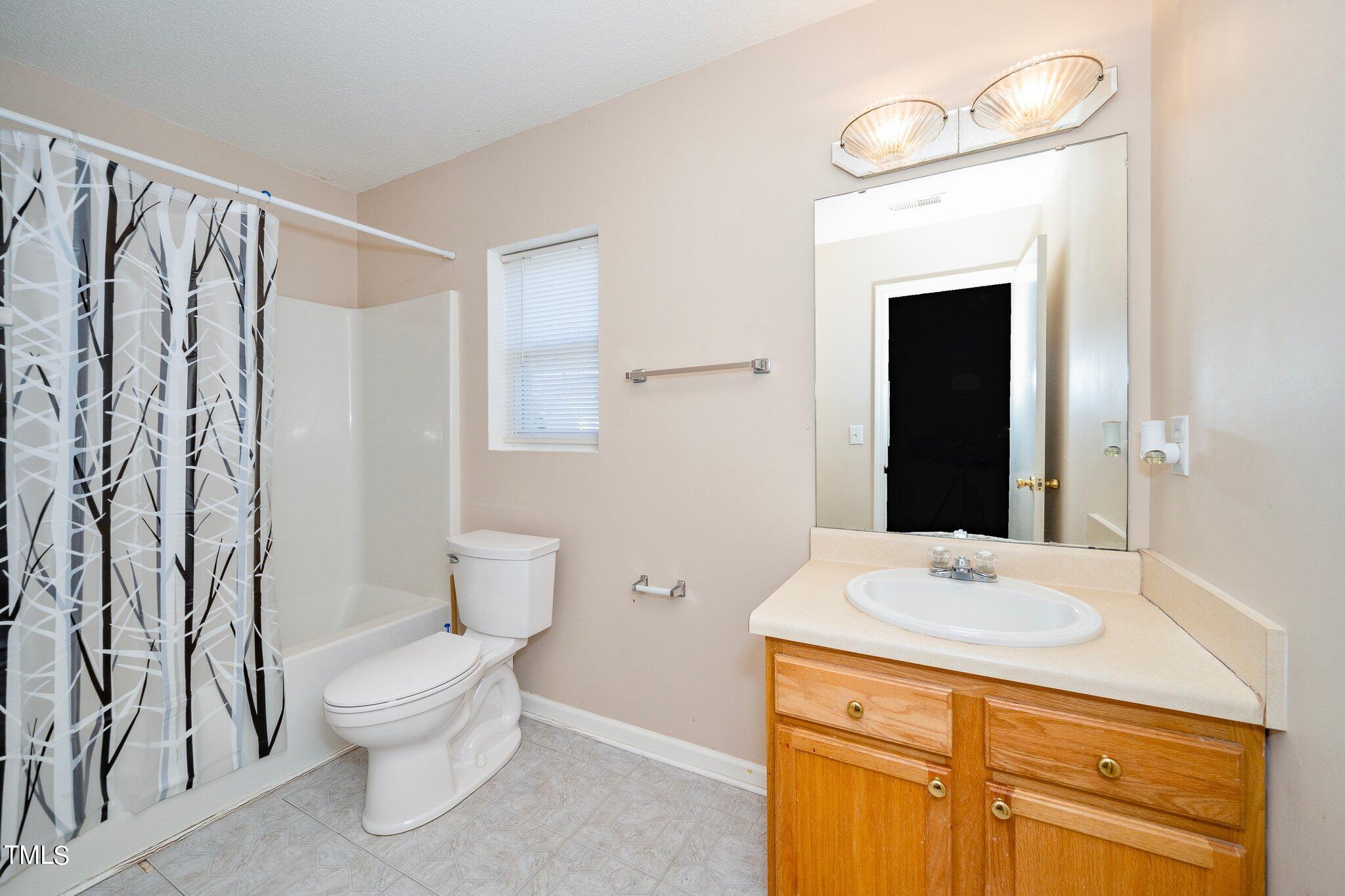 3801 Tryon Ridge Drive Raleigh, NC 27610 - Photo 13 of 23 a bathroom with a sink a toilet and shower