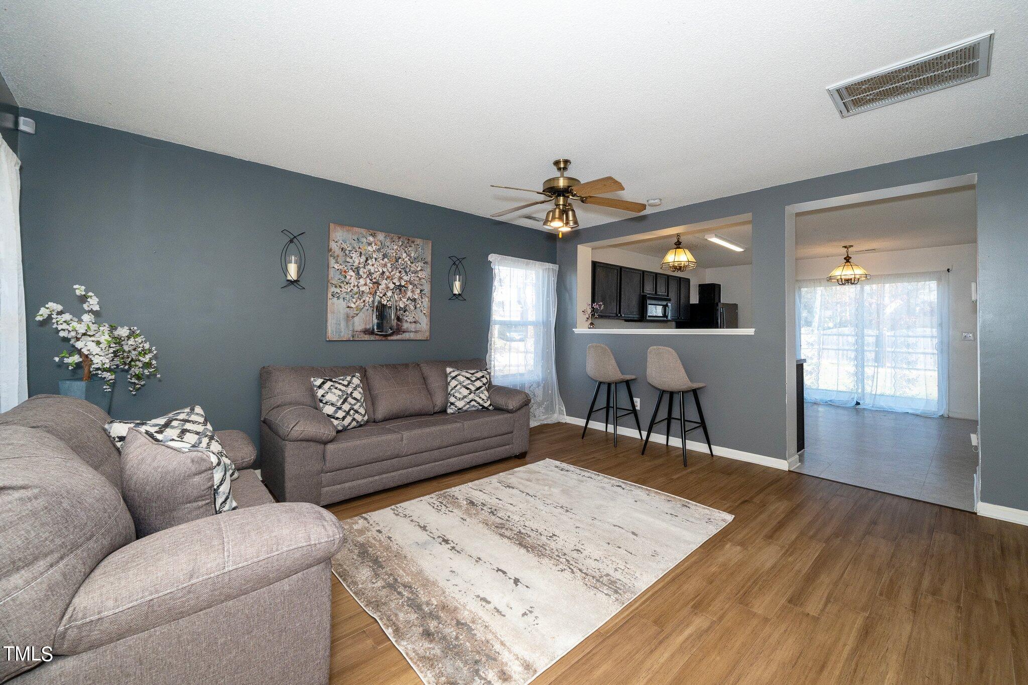 3801 Tryon Ridge Drive Raleigh, NC 27610 - Photo 5 of 23 a living room with furniture and wooden floor