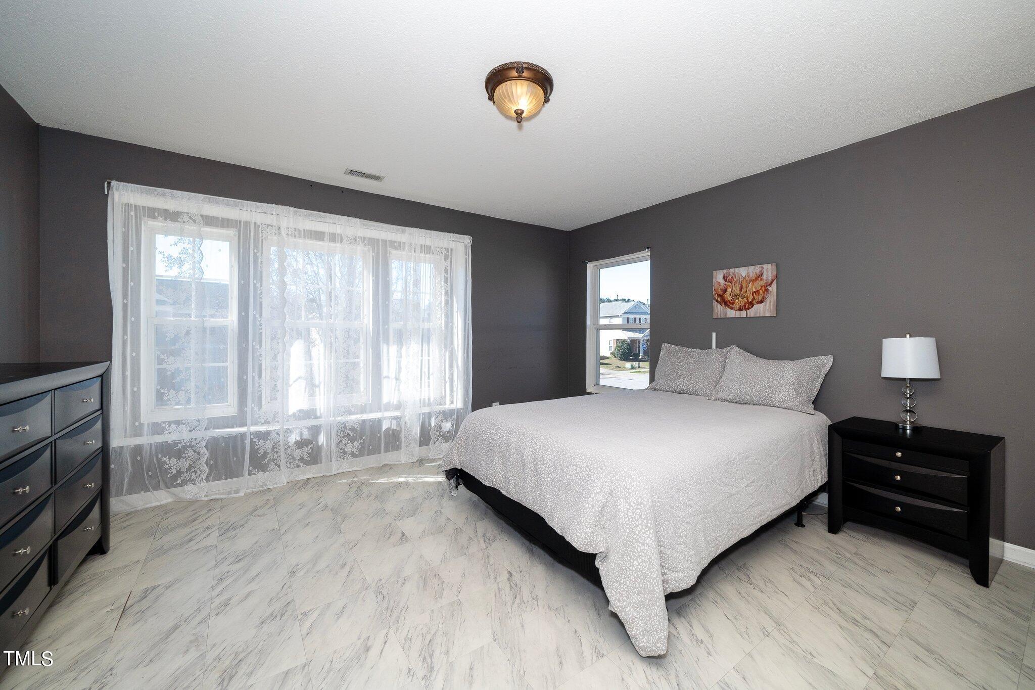 3801 Tryon Ridge Drive Raleigh, NC 27610 - Photo 10 of 23 a bedroom with a bed and a window