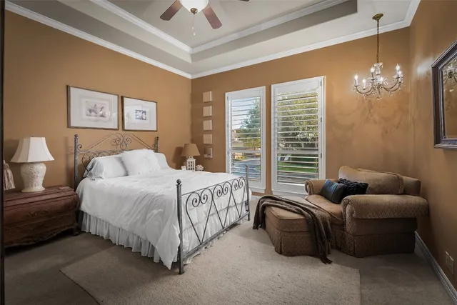 a bedroom with bed furniture and a chandelier