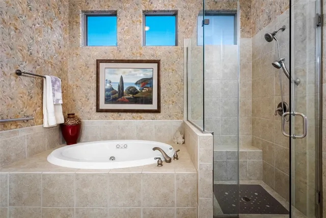 a bathroom with a tub and shower