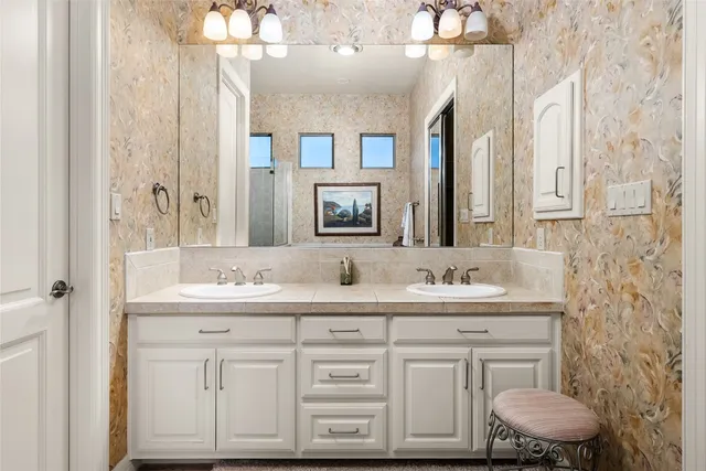a bathroom with a double vanity sink mirror and