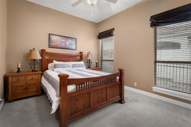 a bed sitting in a bedroom next to a window