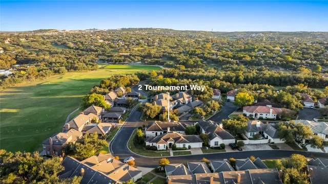 an aerial view of residential houses with outdoor space and swimming pool