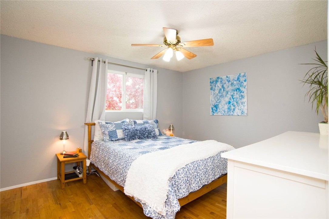 11510 Southeast 178th Place Renton, WA 98055 - Photo 11 of 18 a bedroom with a bed and a chandelier