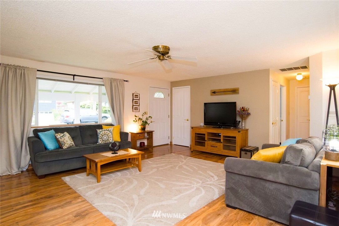 11510 Southeast 178th Place Renton, WA 98055 - Photo 5 of 18 a living room with furniture and a flat screen tv
