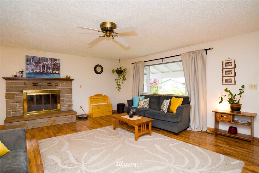 11510 Southeast 178th Place Renton, WA 98055 - Photo 6 of 18 a living room with furniture and a fireplace